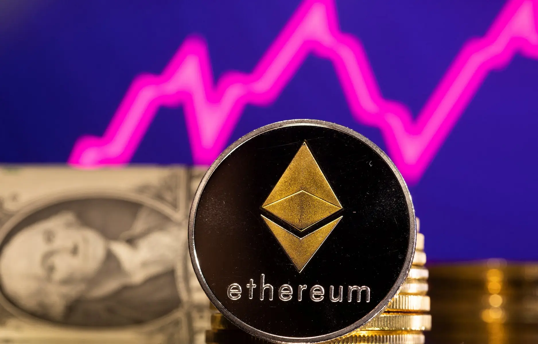 Close-up of a black and gold Ethereum coin featuring the diamond-shaped token symbol
