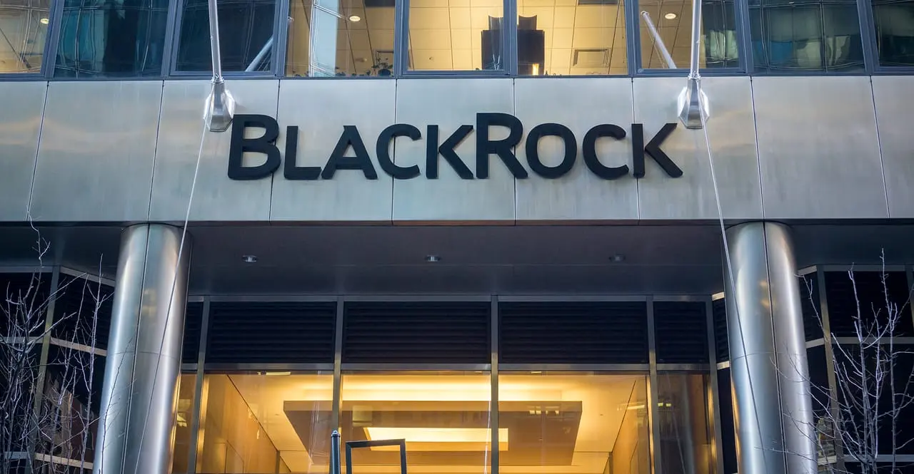 BlackRock corporate logo mounted on the silver metallic facade of an office building entrance