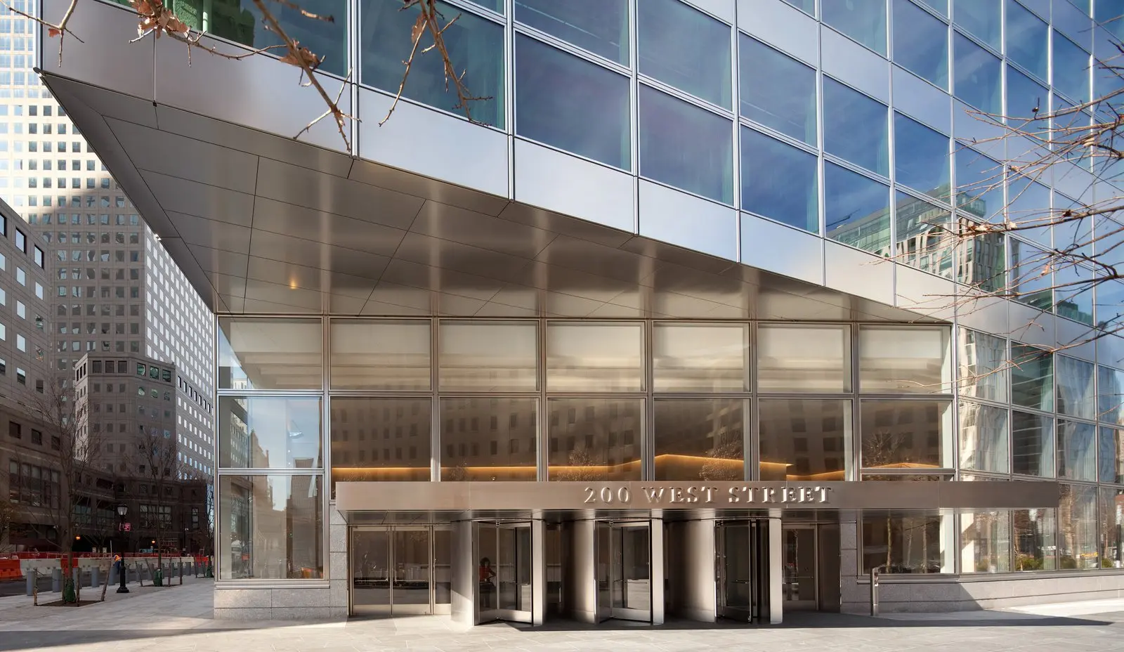 The modern glass and steel exterior and entrance of 200 West Street in New York City
