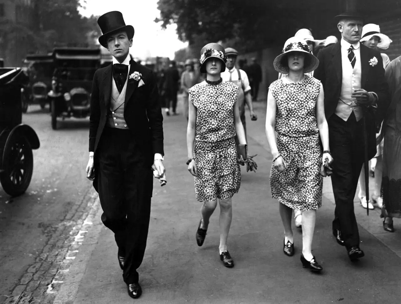 Fotografia antiga em preto e branco de Cecil Beaton e suas irmãs, Nancy e Barbara, caminhando.